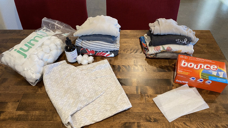 Table with T-shirts, laundry supplies, cotton balls