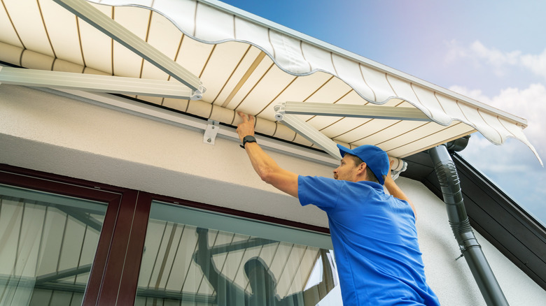 man working on patio awning