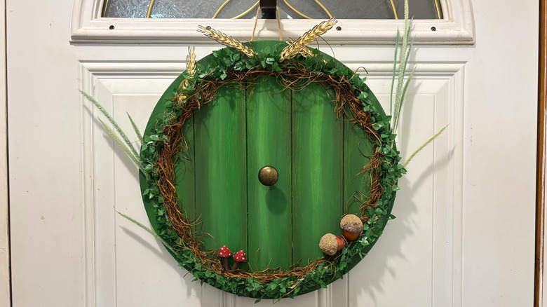 Green DIY hobbit wreath on a white door