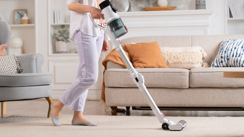 Woman vacuuming carpet