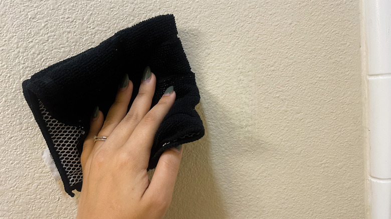 scrubbing wall with cloth