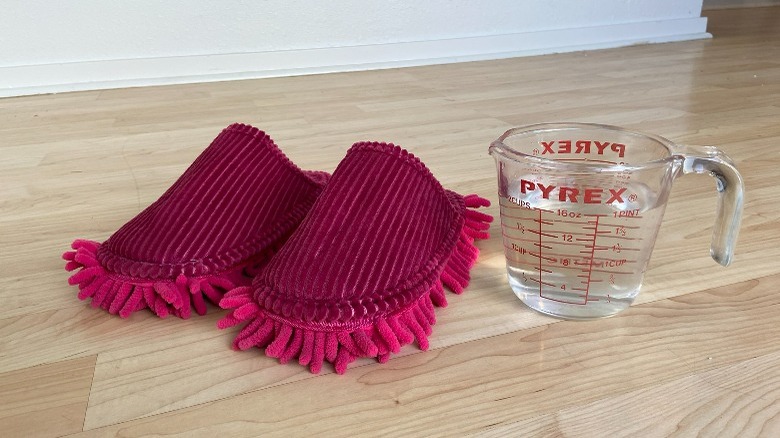 Pink slippers by glass of water