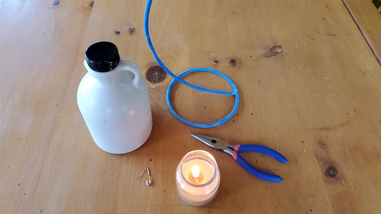 plastic bottle, candle and tools