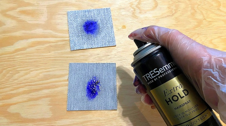 Spraying hairspray on fabric swatches