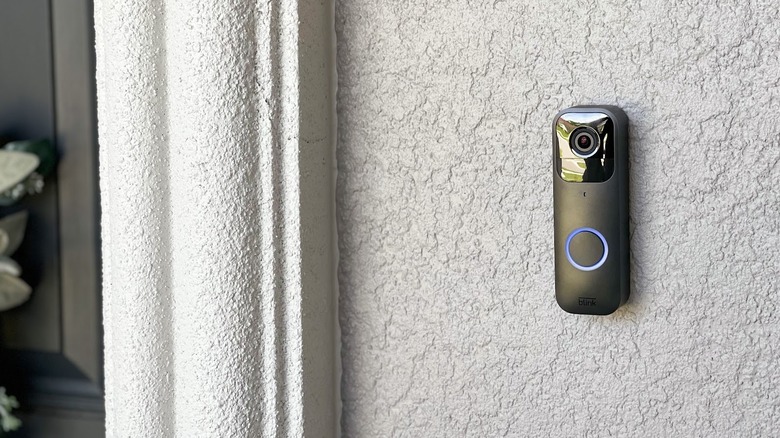 doorbell mounted on exterior wall illuminated