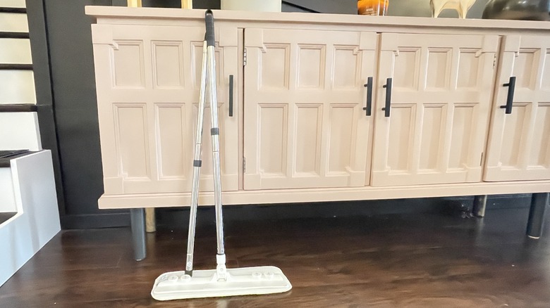 Mop leaning against cabinet