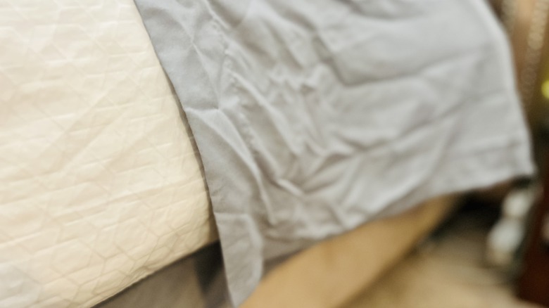 Wrinkled sheets on bed