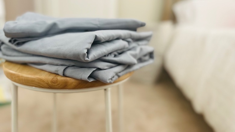 Sheets folded on stool