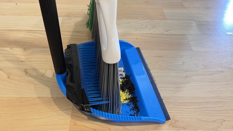 Sweeping dirt into dustpan