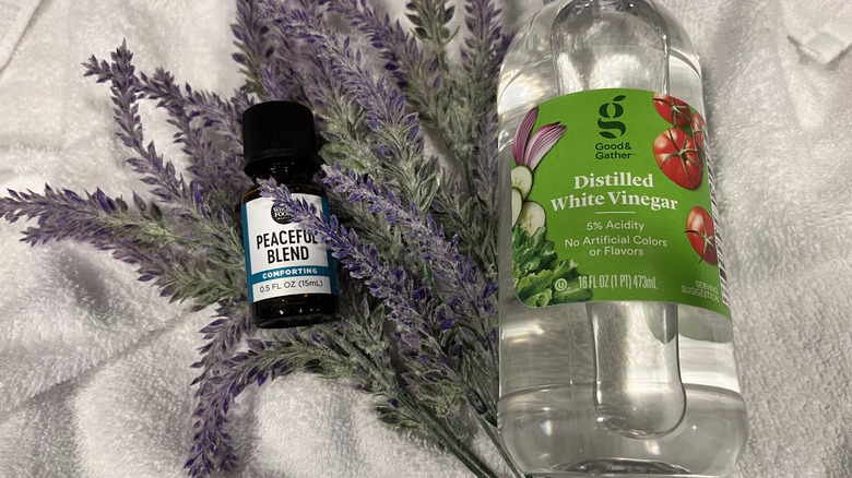 Essential oil with lavender sprig and vinegar