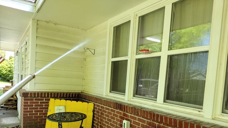 washing windows with a hose