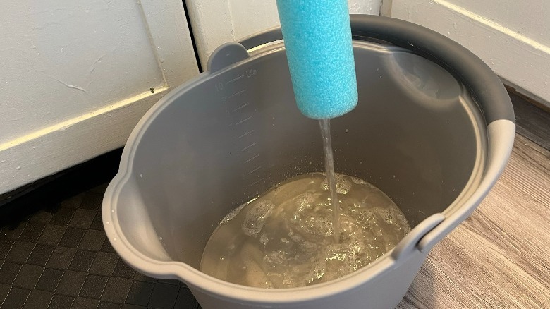 Bucket filling with water 