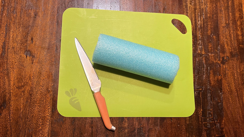 pool noodle on cutting board