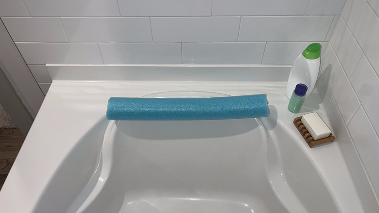 pool noodle headrest in bathtub