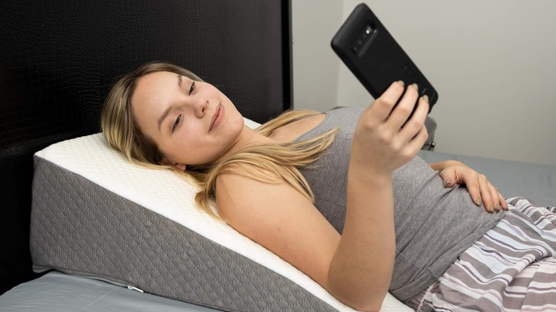 Woman on phone wedge pillow