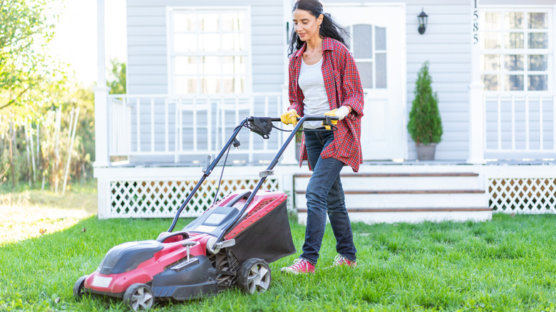 Woman pushing lawnmower