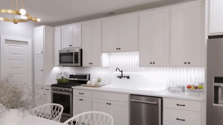 all-white kitchen with stainless steel appliances