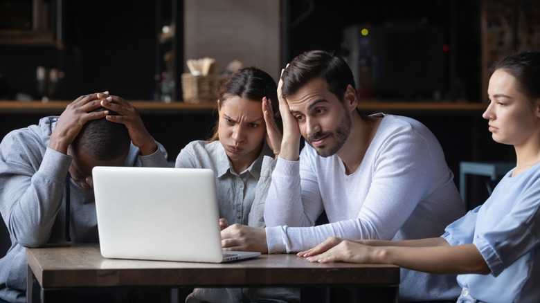 People looking frustrated at computer