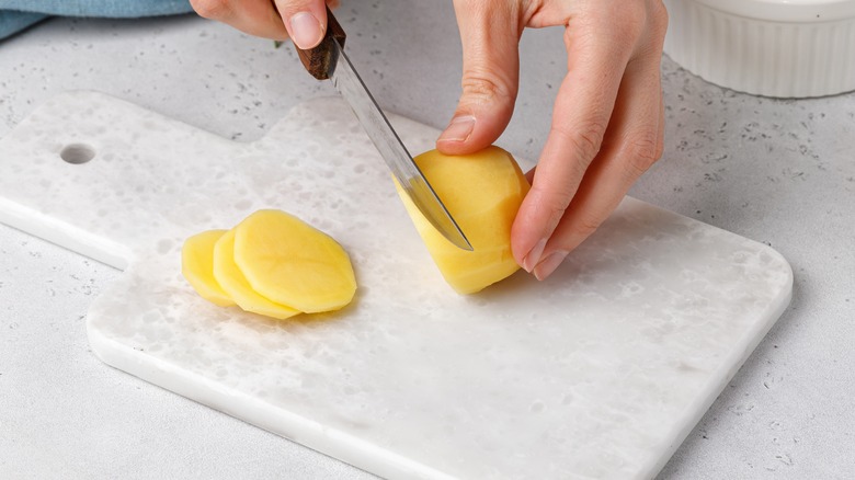 Person cutting potatoes