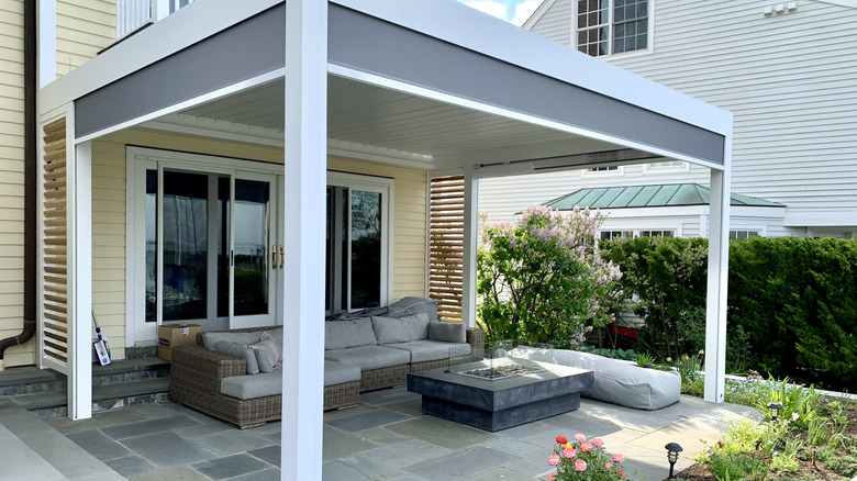 Pergola attached to a yellow house