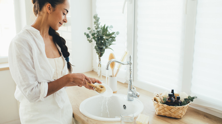 Cleaning dishes with bamboo brush