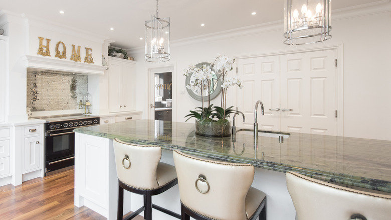 A kitchen with a green quartzite island