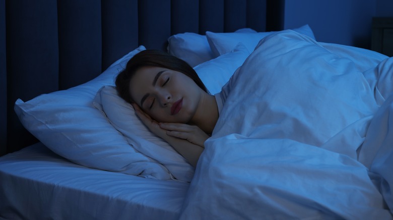 Woman sleeping in bed at night