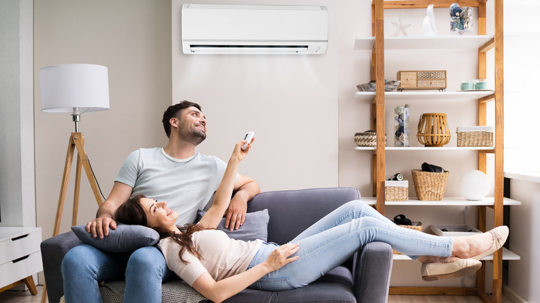couple relaxing on couch with AC unit