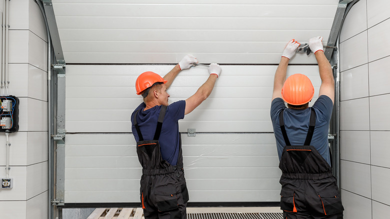 Men work on garage door