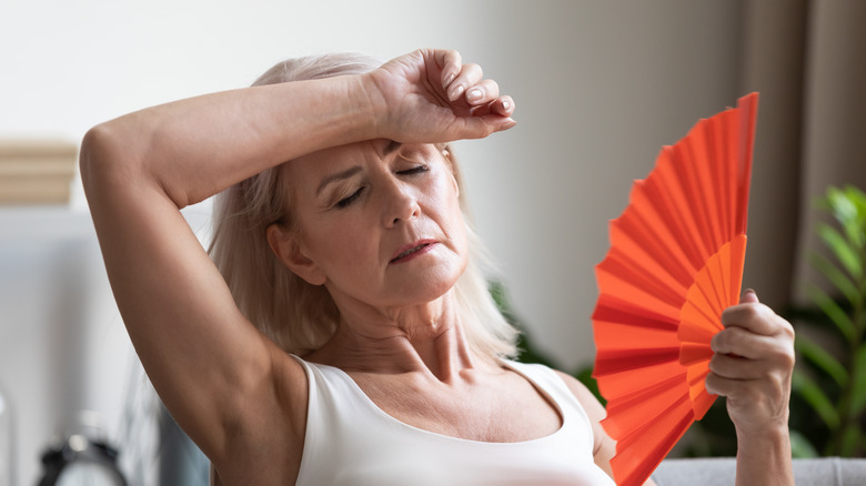 woman holding hand fan