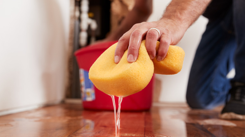 man cleaning up a leak