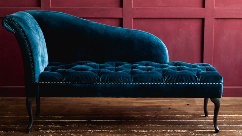 blue couch in burgundy room