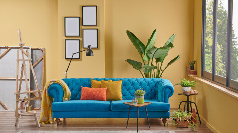 blue couch in yellow room