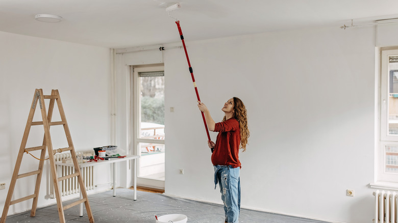 Woman painting ceiling