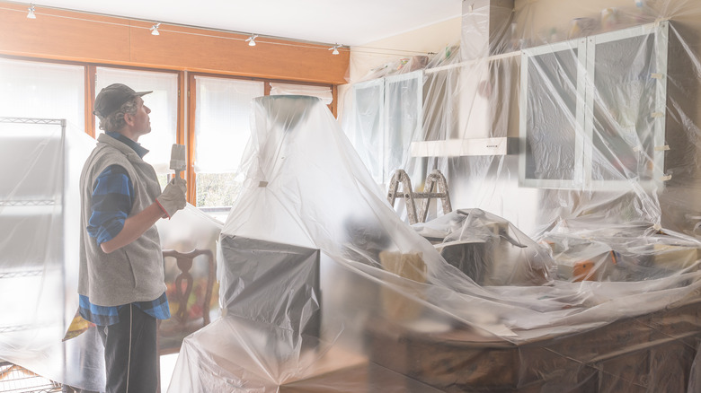 man painting a kitchen