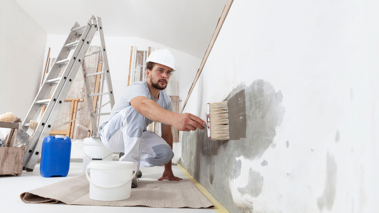 Person painting wall