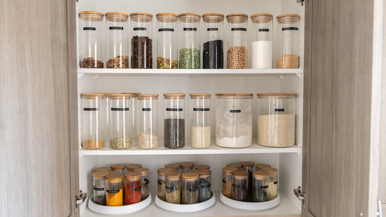 Organized clear containers and rotating shelves in a pantry