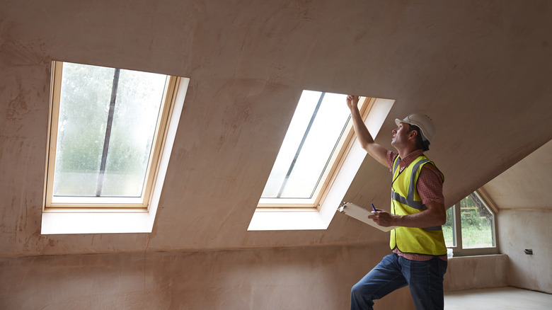 a builder checking loft windows