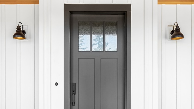 Black front door on white house