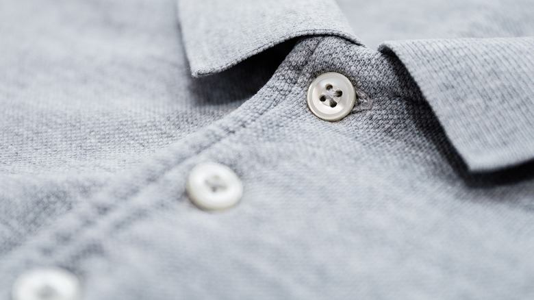 Closeup of light gray buttoned up shirt