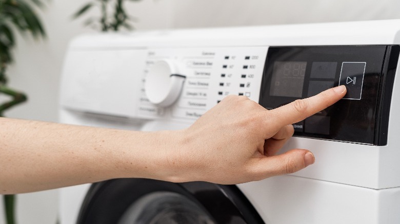 Closeup of hand pointing to washer setting