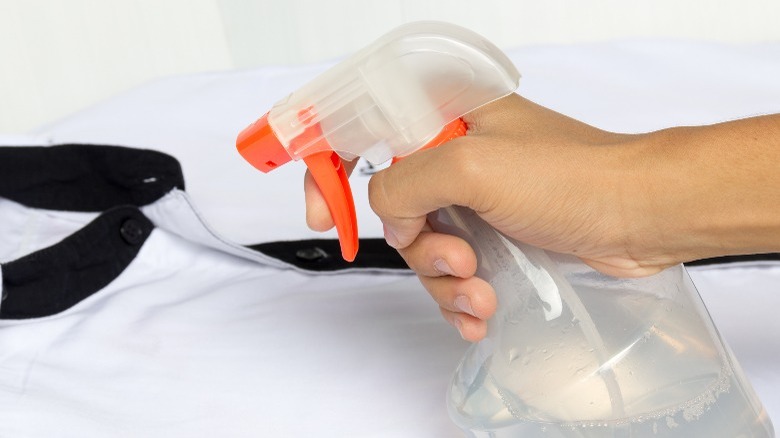 Spray bottle, white shirt with black collar