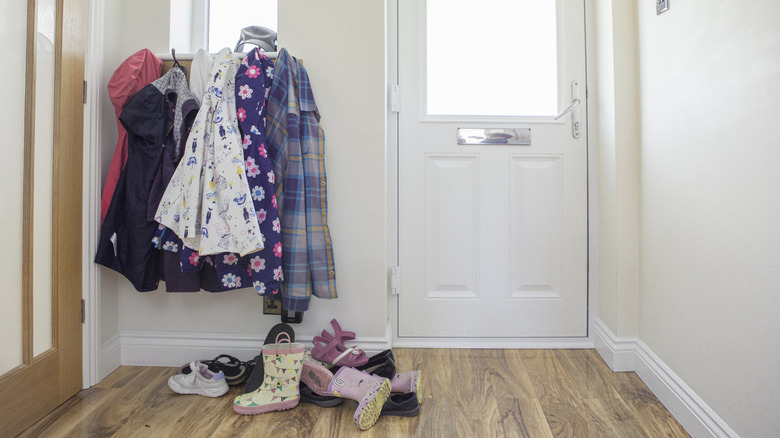 Messy jackets and shoes by the front door