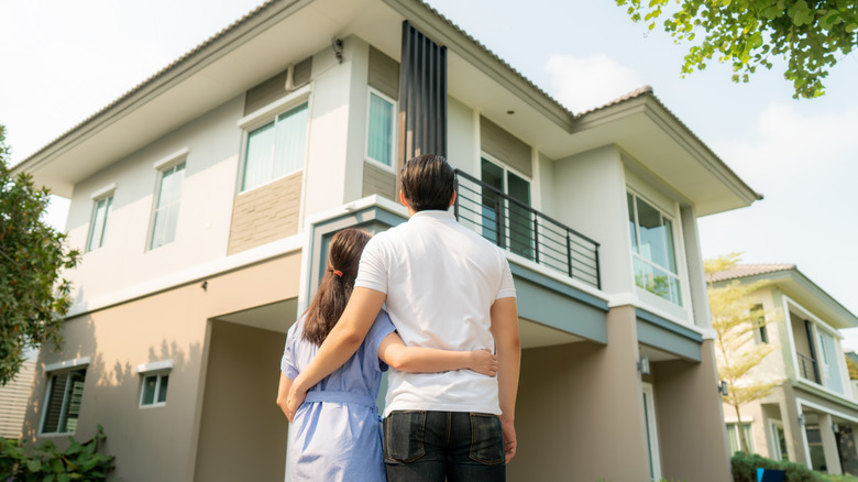 Couple looking up at house