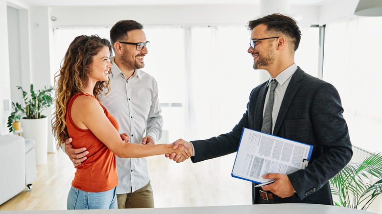 realtor shaking hands with clients