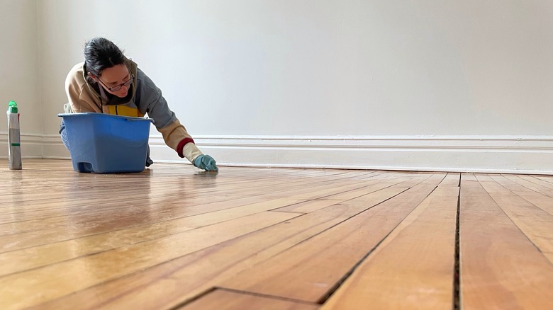 Woman applying wood restorer