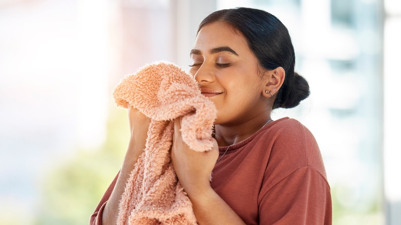 Woman smelling fresh laundry