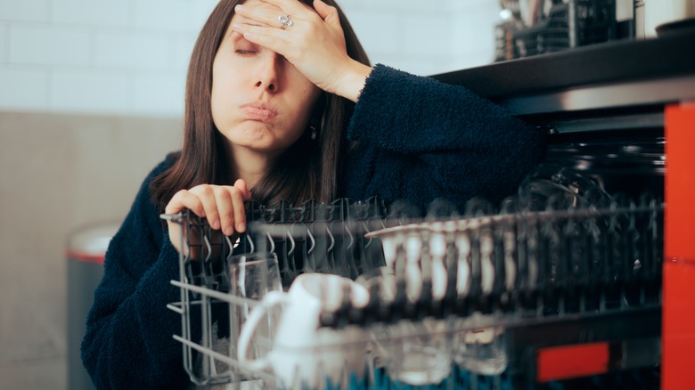 Person with broken dishwasher