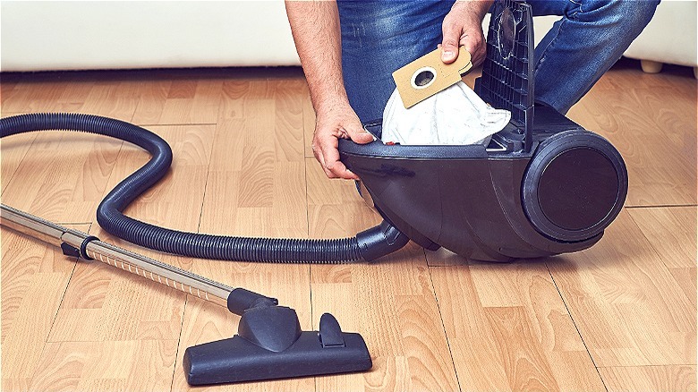 Person removing bag from vacuum