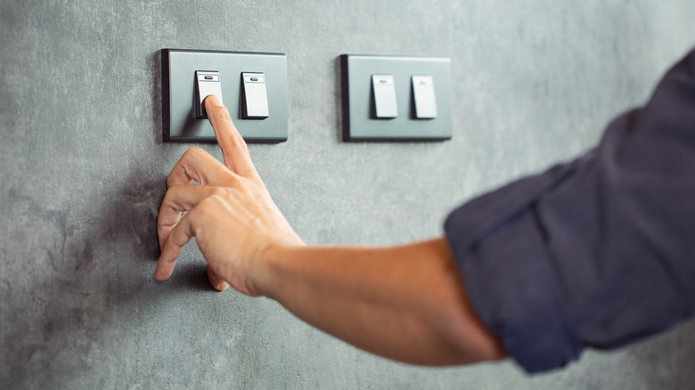 finger operating a switch